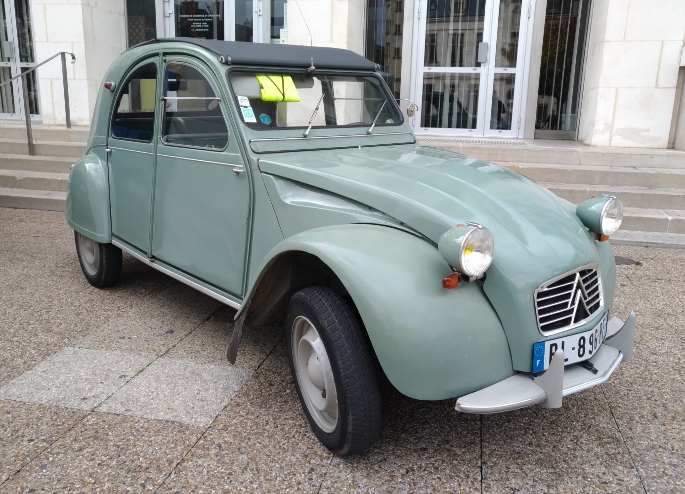 Rounded headlights and soft fabric roof on classic vintage economy car