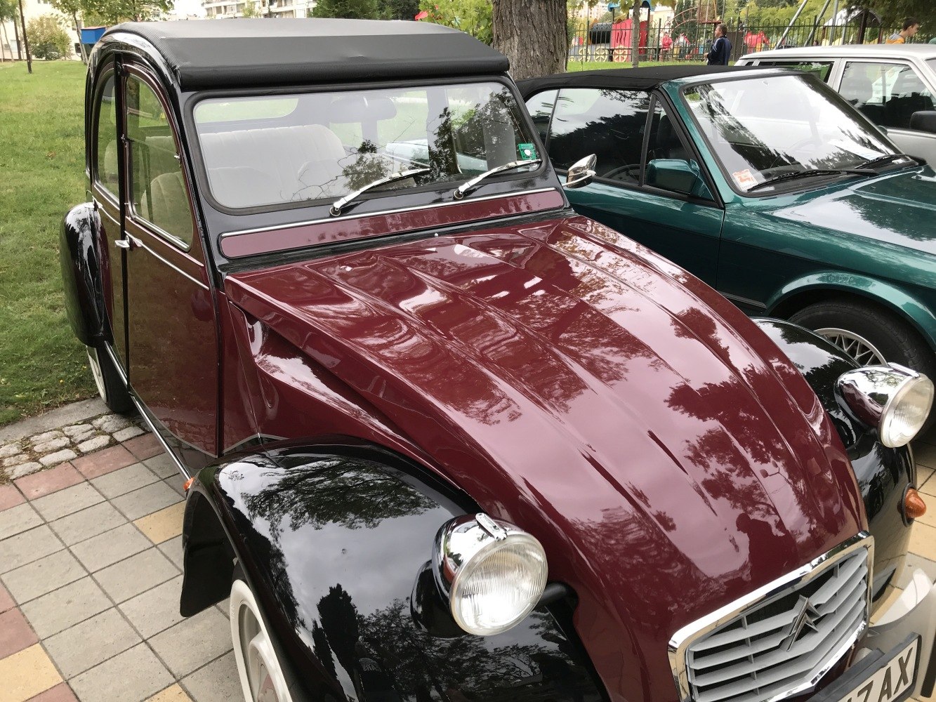 Rounded front hood, large circular headlights, and classic fenders