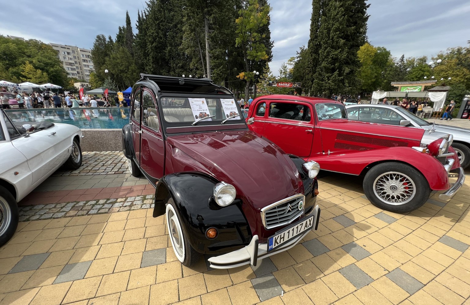 Vintage hatchback with rounded headlights, whitewall tires, two-tone paint