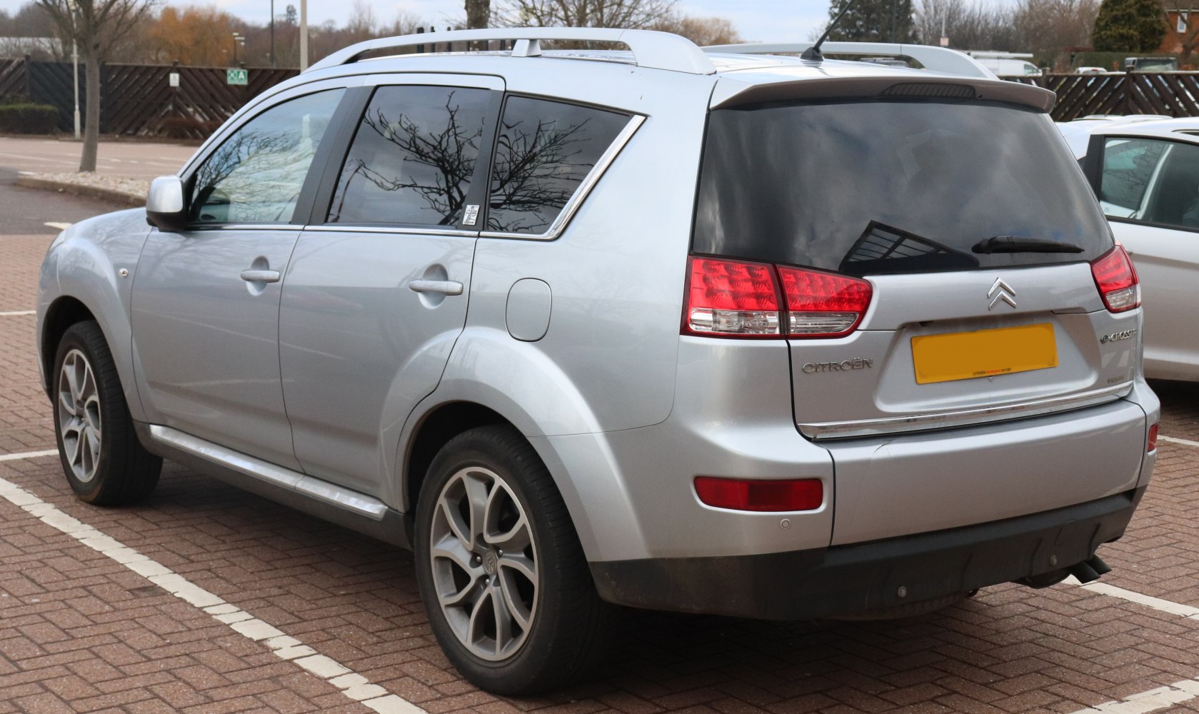 Silver SUV rear side with tinted windows and alloy wheels
