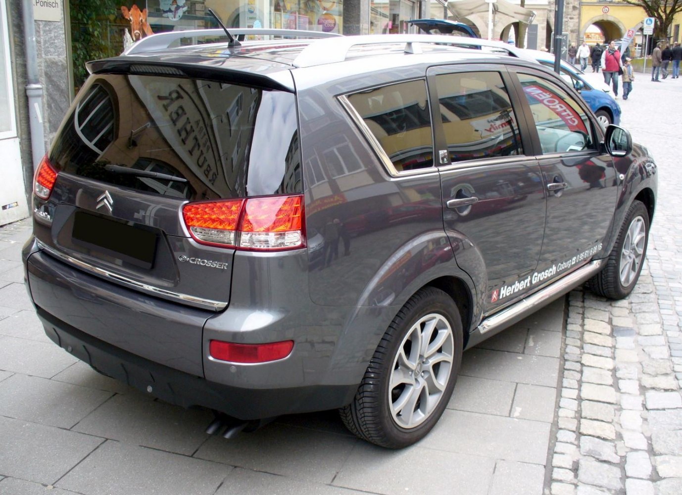Rear and side view of SUV with alloy wheels and roof rails
