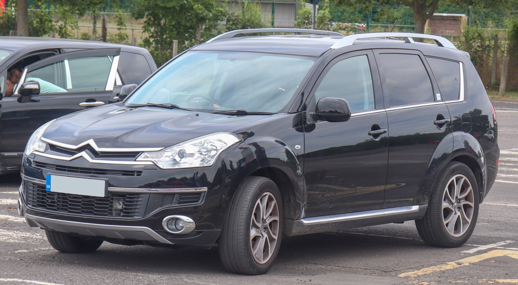 Front and side view of SUV with roof rails and alloy wheels