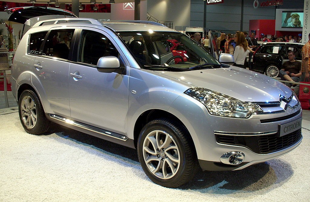 Silver SUV front side view with alloy wheels and roof rails