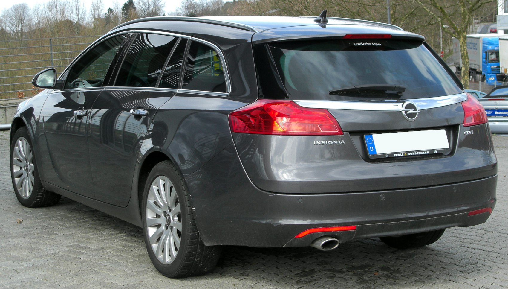 Rear view of a mid-size station wagon with sleek tail lights and chrome trim