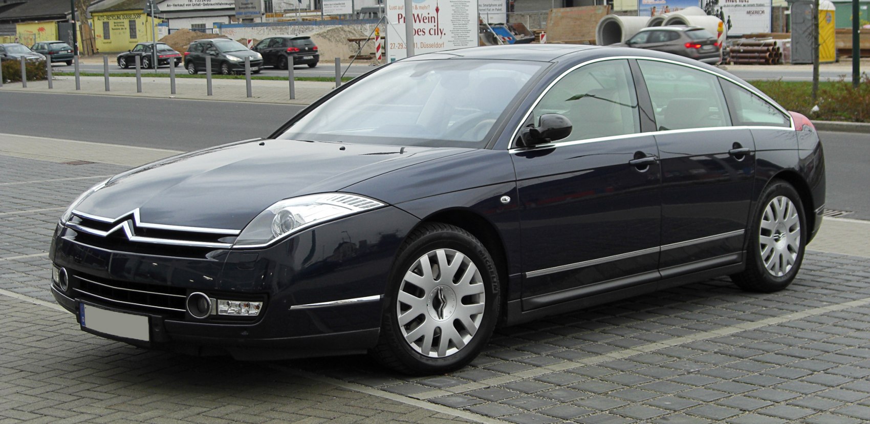Sleek sedan with aerodynamic design and chrome trim on front side view