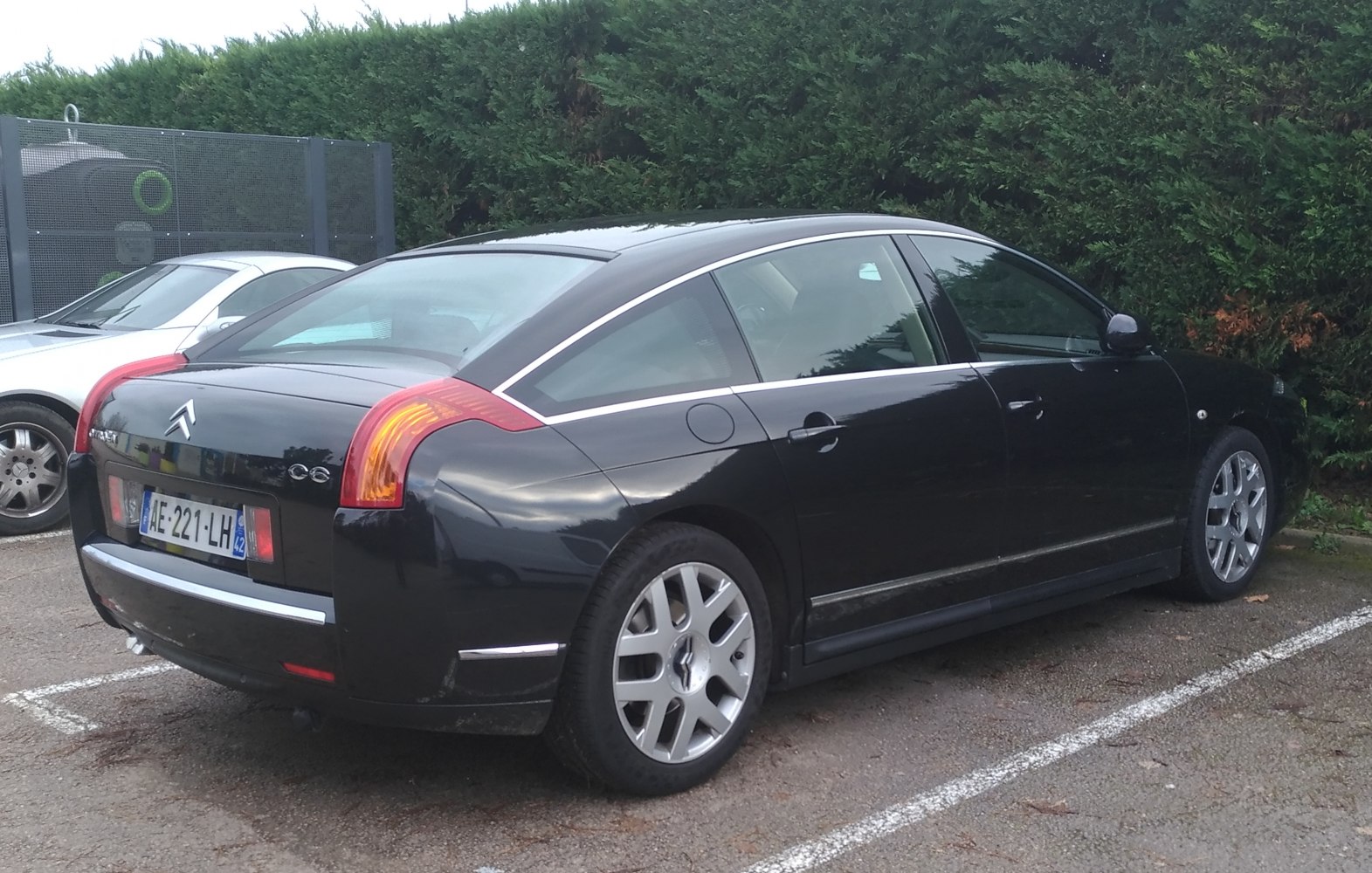 Sleek black luxury sedan rear and side view with distinct taillights and alloy wheels