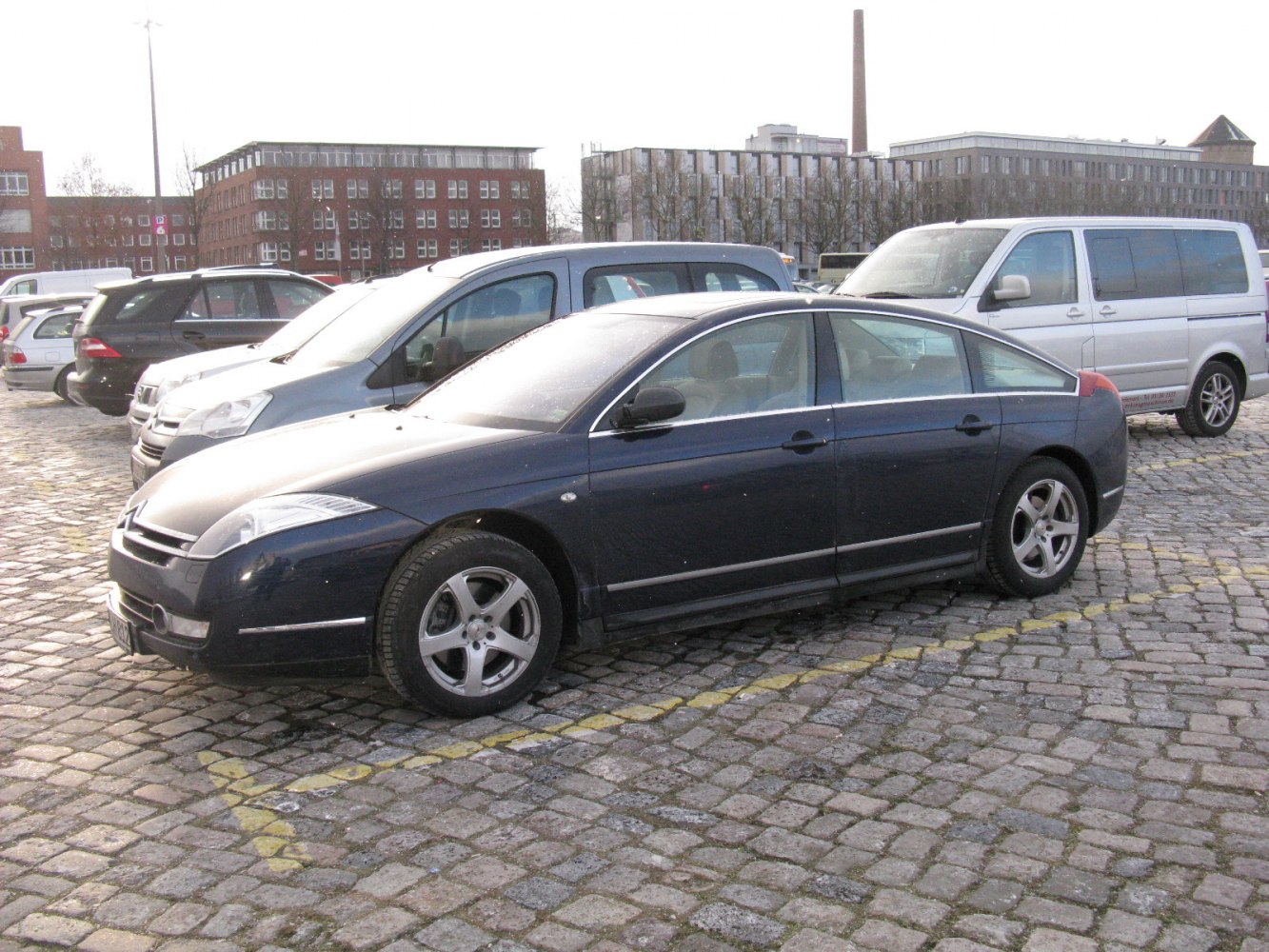Sleek sedan side profile with sharp front headlights and smooth lines
