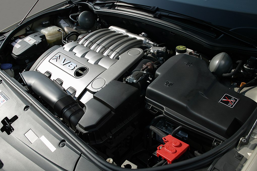 Close-up of a V6 engine with detailed components in a car's engine bay