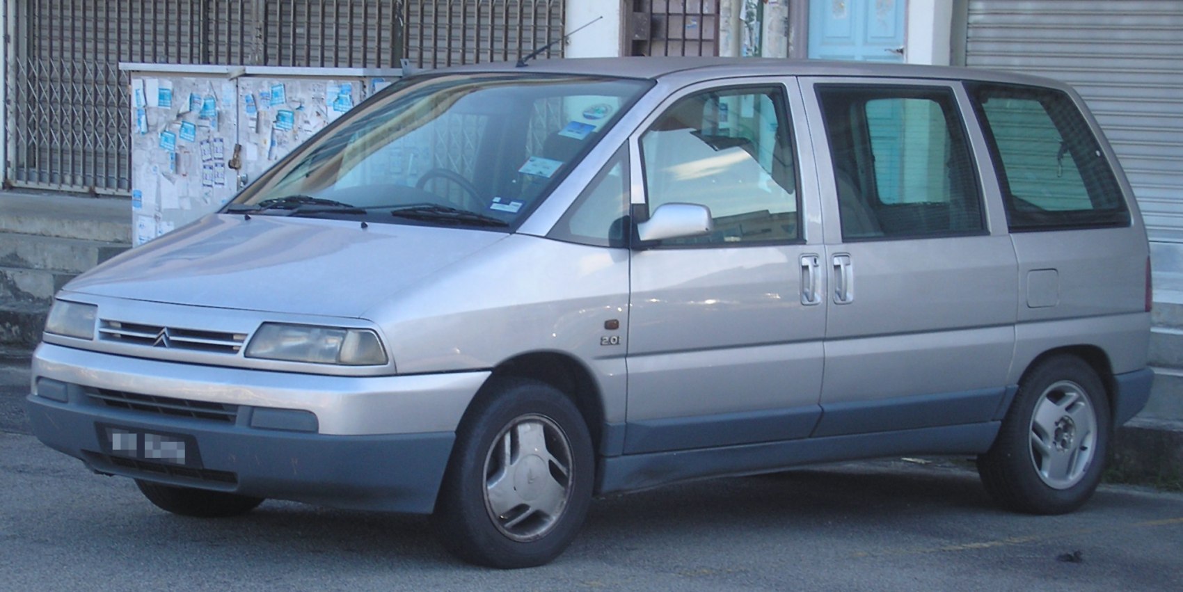 Silver mid-90s MPV with sliding side doors and multi-window design