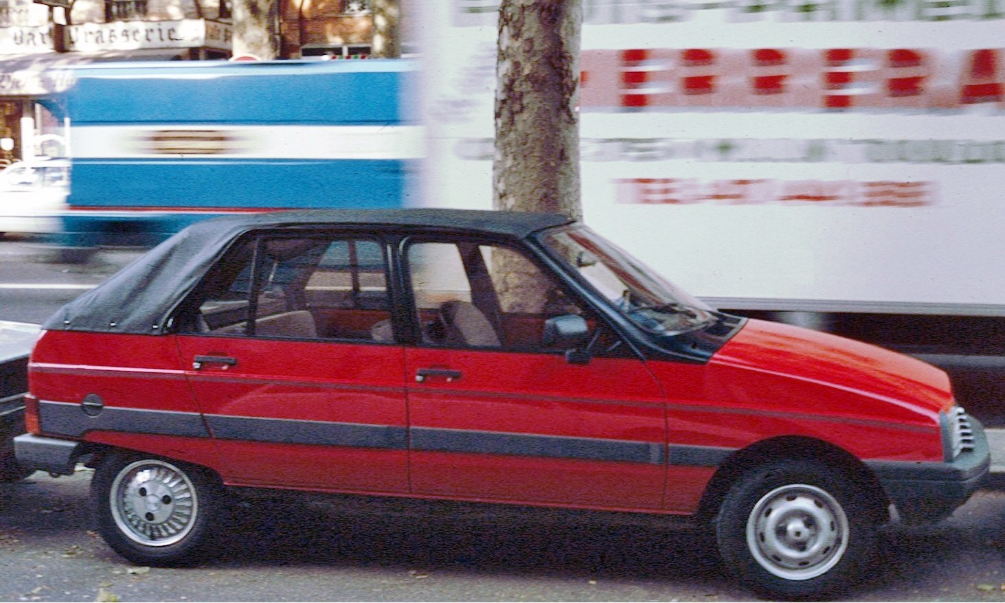 Red convertible with black soft top and four doors
