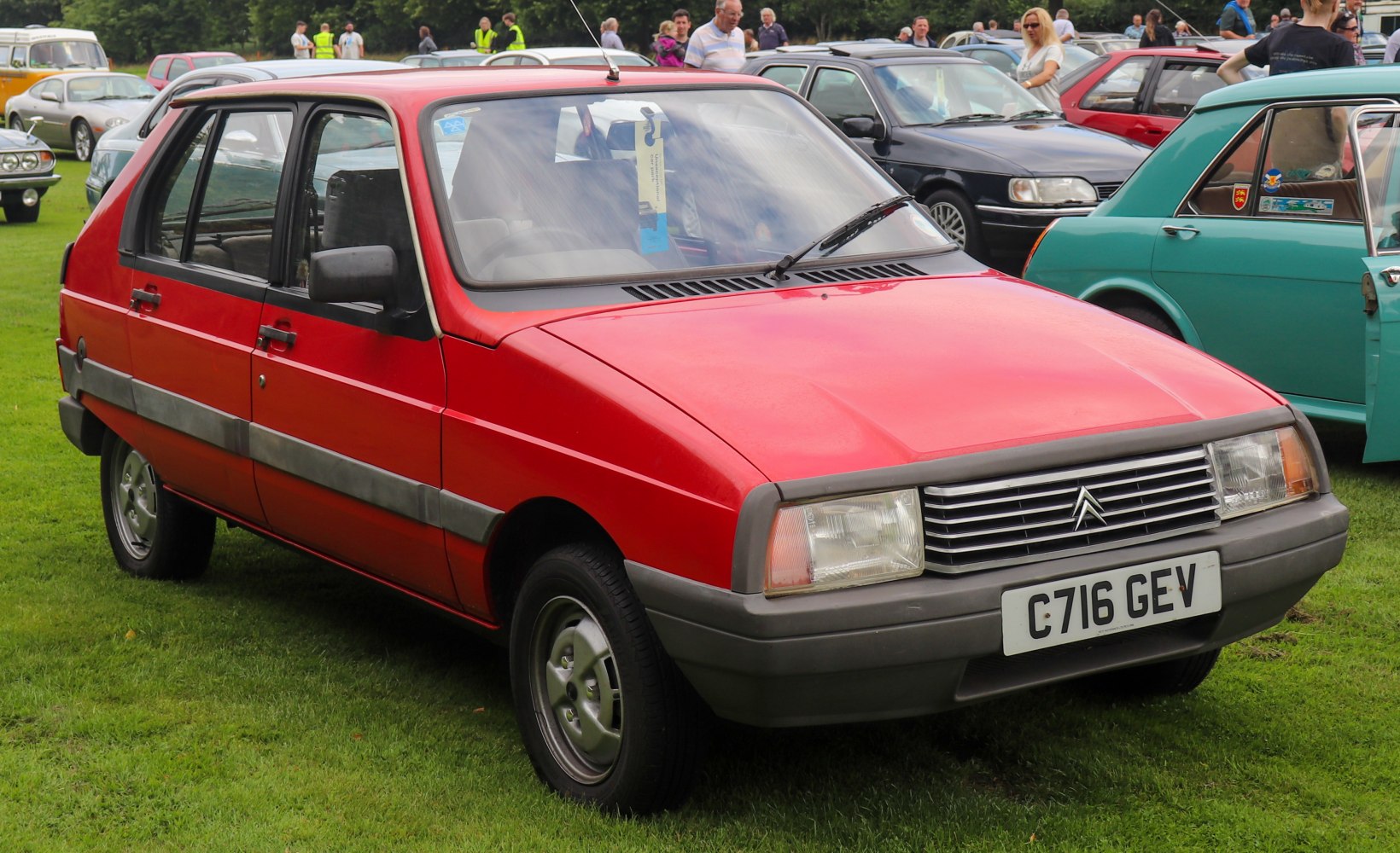 Red hatchback with angular body and distinctive front grille