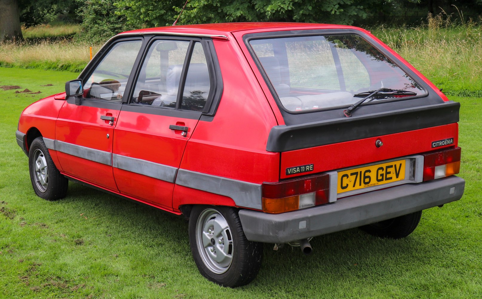 Red five-door hatchback with rear spoiler and black trim