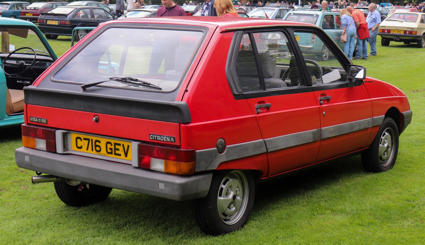 Vintage hatchback with black rear spoiler and gray side moldings