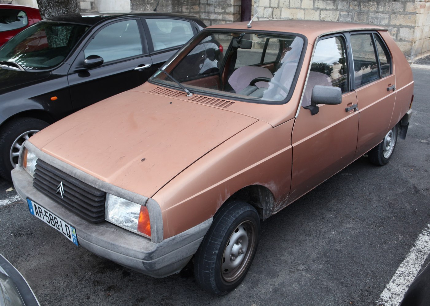 Vintage hatchback with rectangular headlights and plastic bumpers