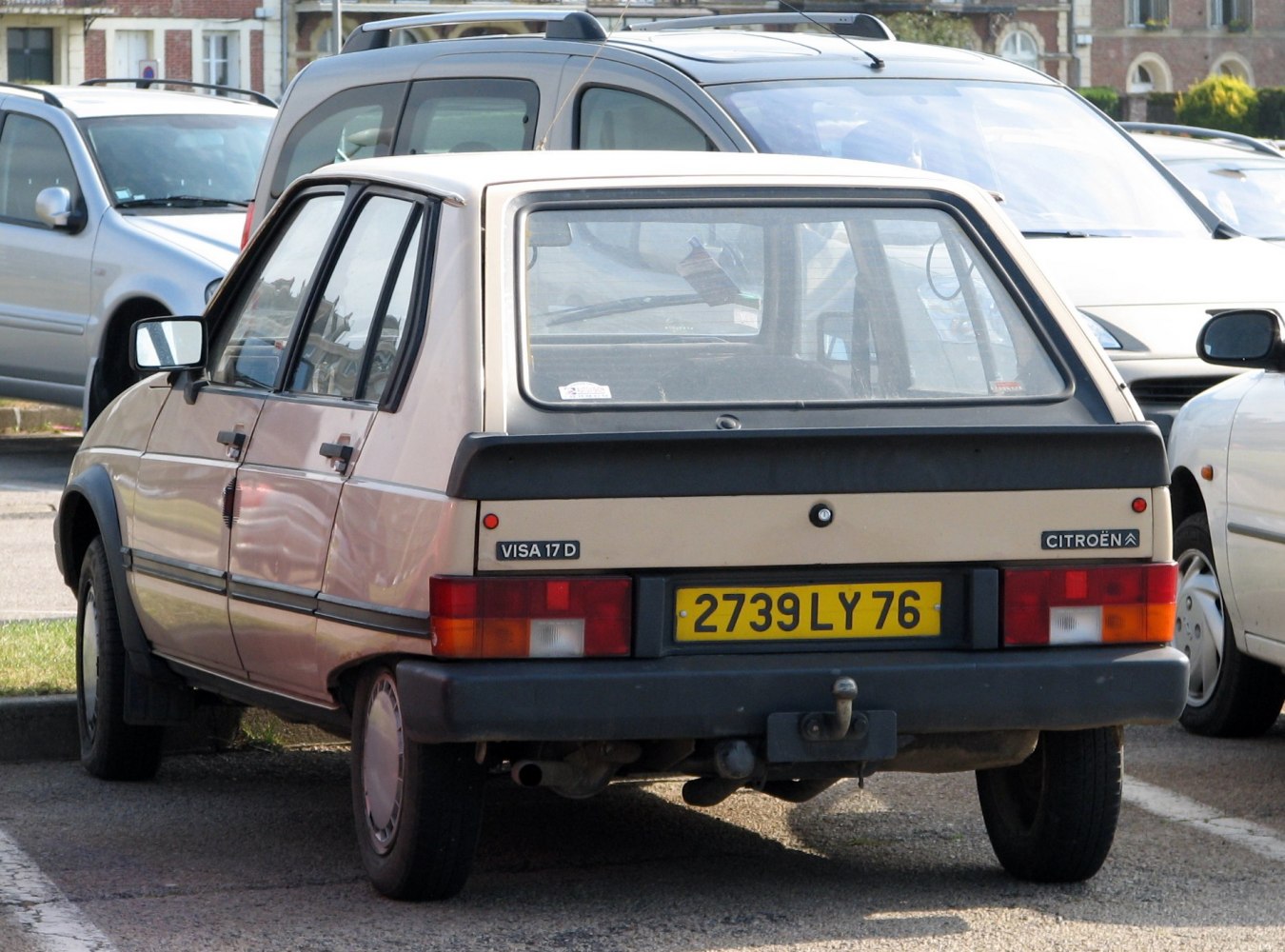 Rear view of a classic hatchback with distinct taillights and a tow hitch