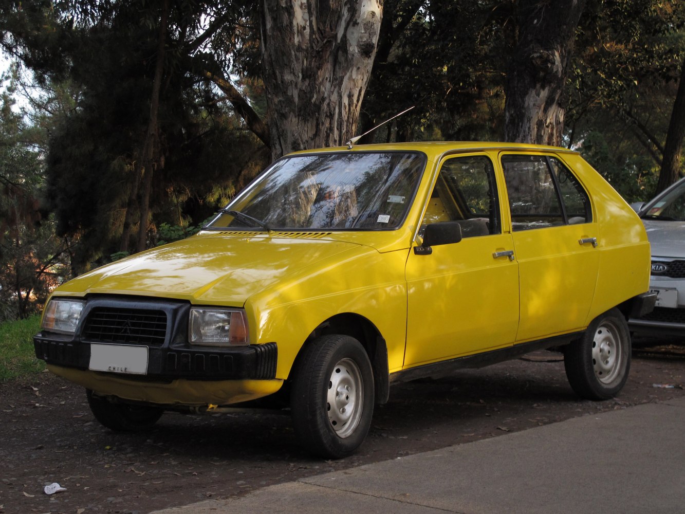 Yellow compact hatchback with black front bumper and steel wheels
