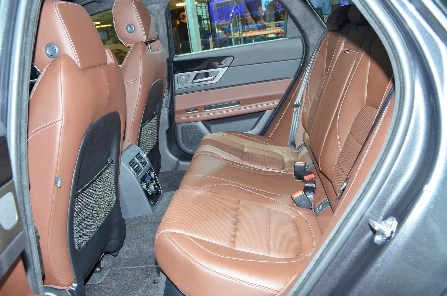 Rear brown leather seats with integrated rear climate controls and seatbelts