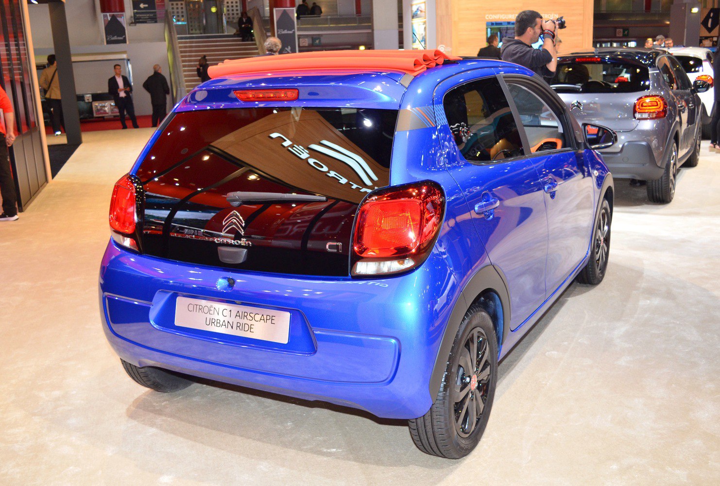 Blue compact 5-door car with folded soft fabric roof