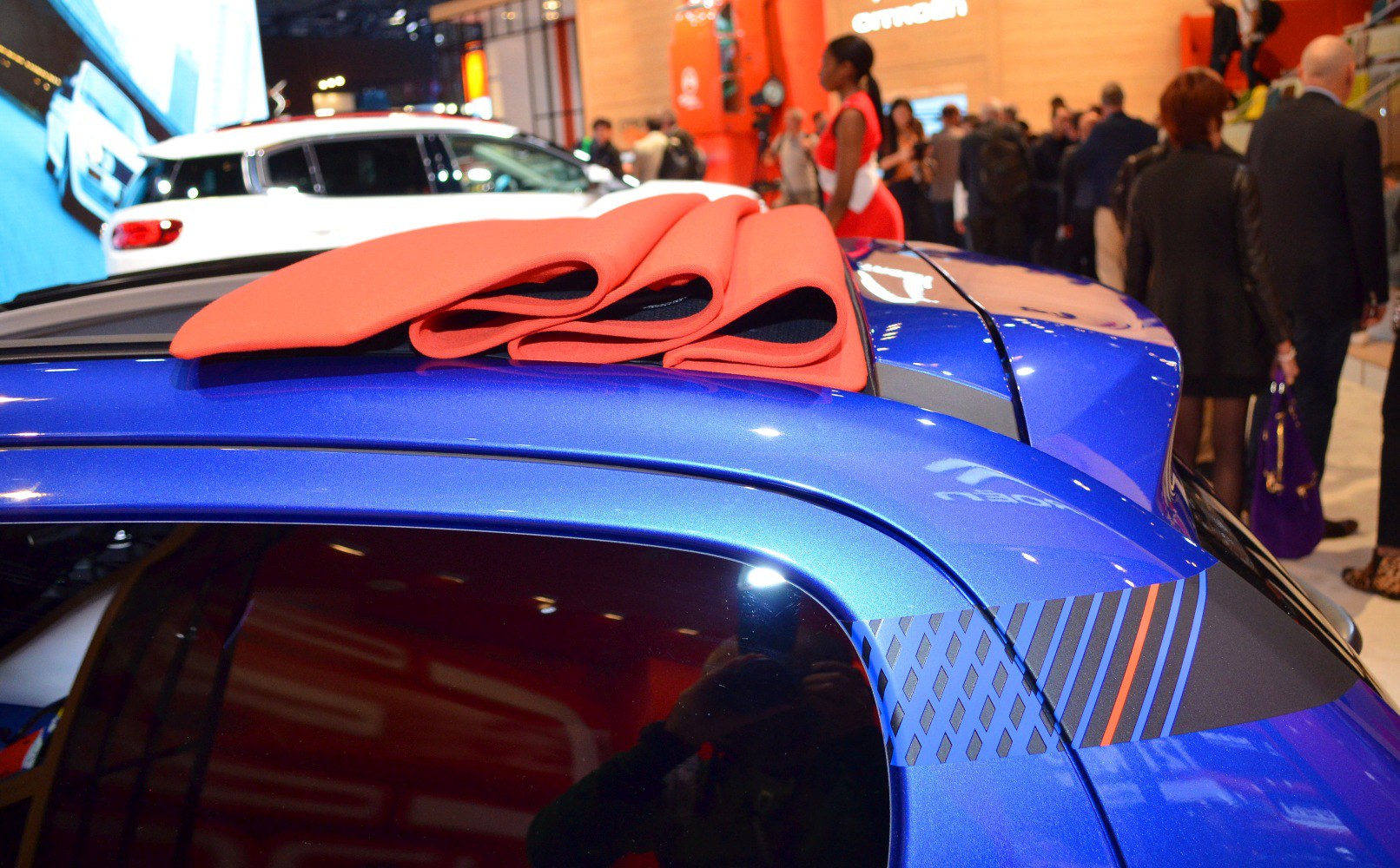 Folded soft top roof fabric on blue compact car.