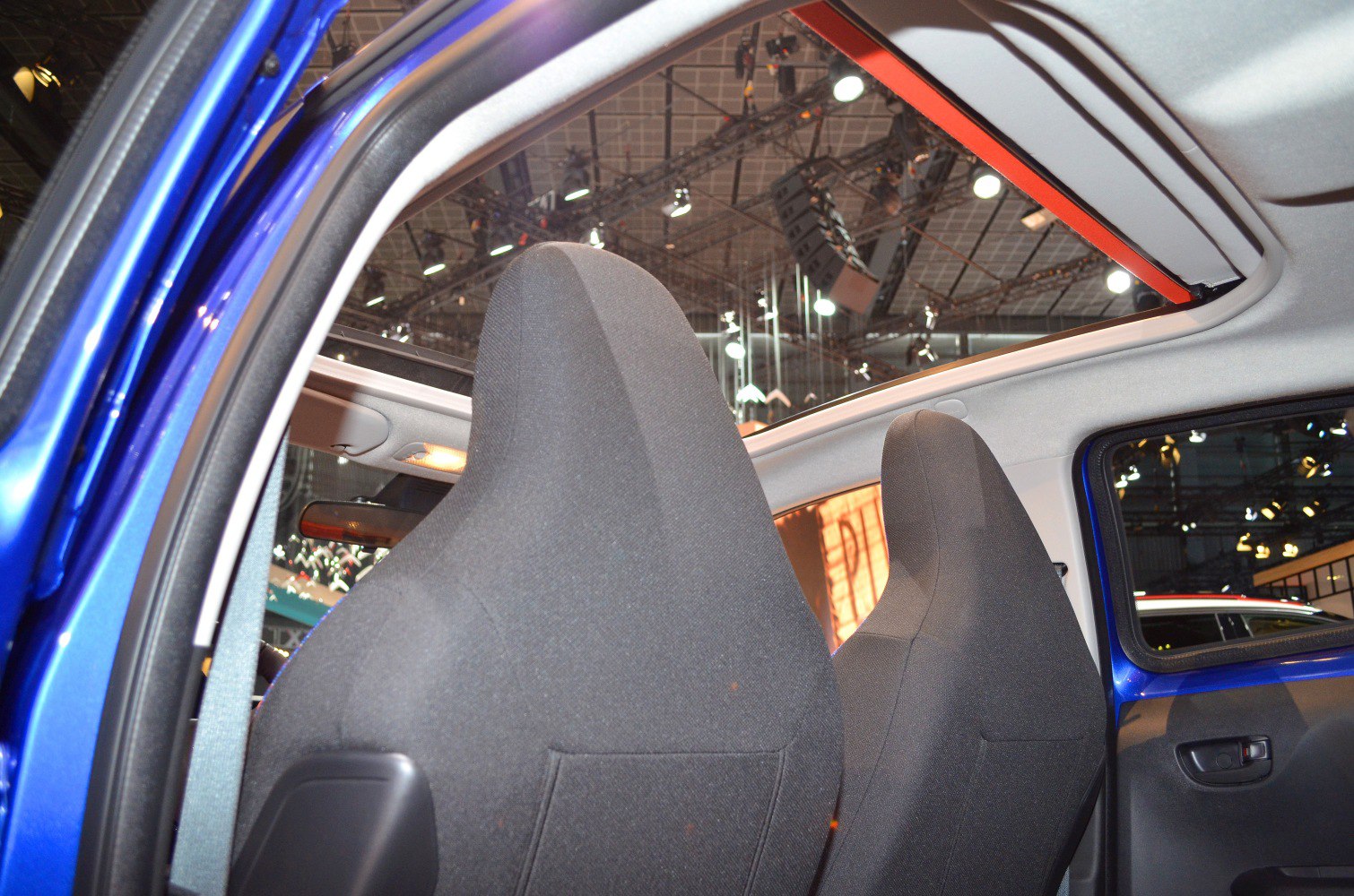 Panoramic glass roof with front seat backs in compact car interior