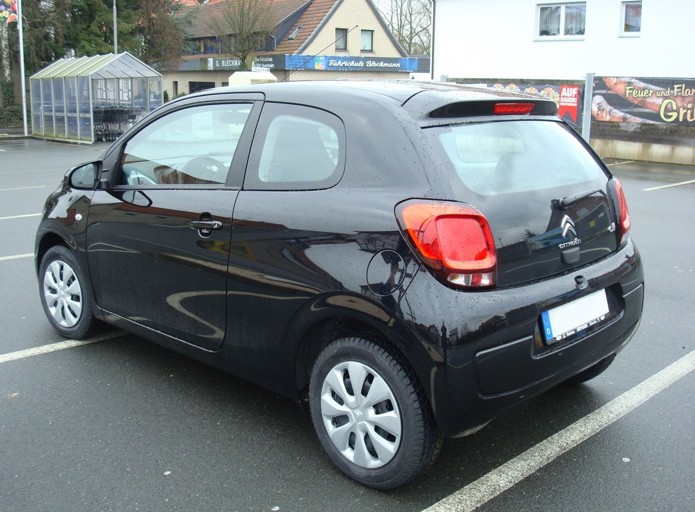 Rear and side view of a 3-door hatchback with distinct tail lights and rear spoiler.
