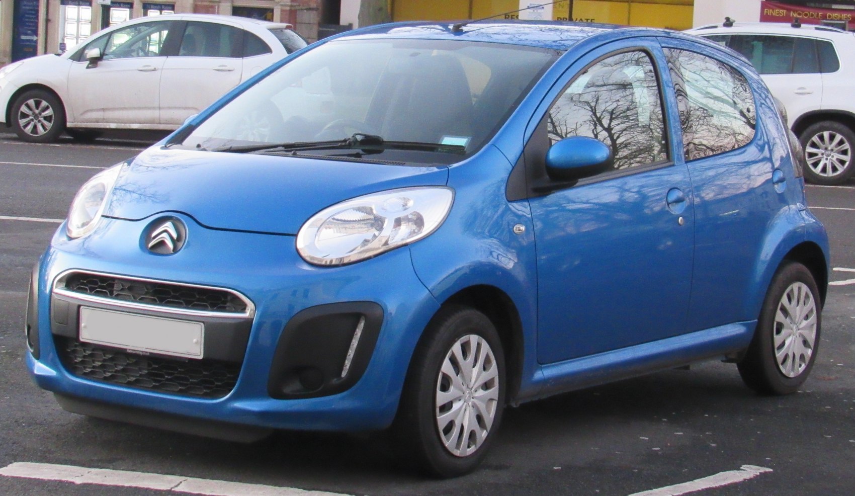 Blue compact hatchback with distinctive front grille and rounded headlights