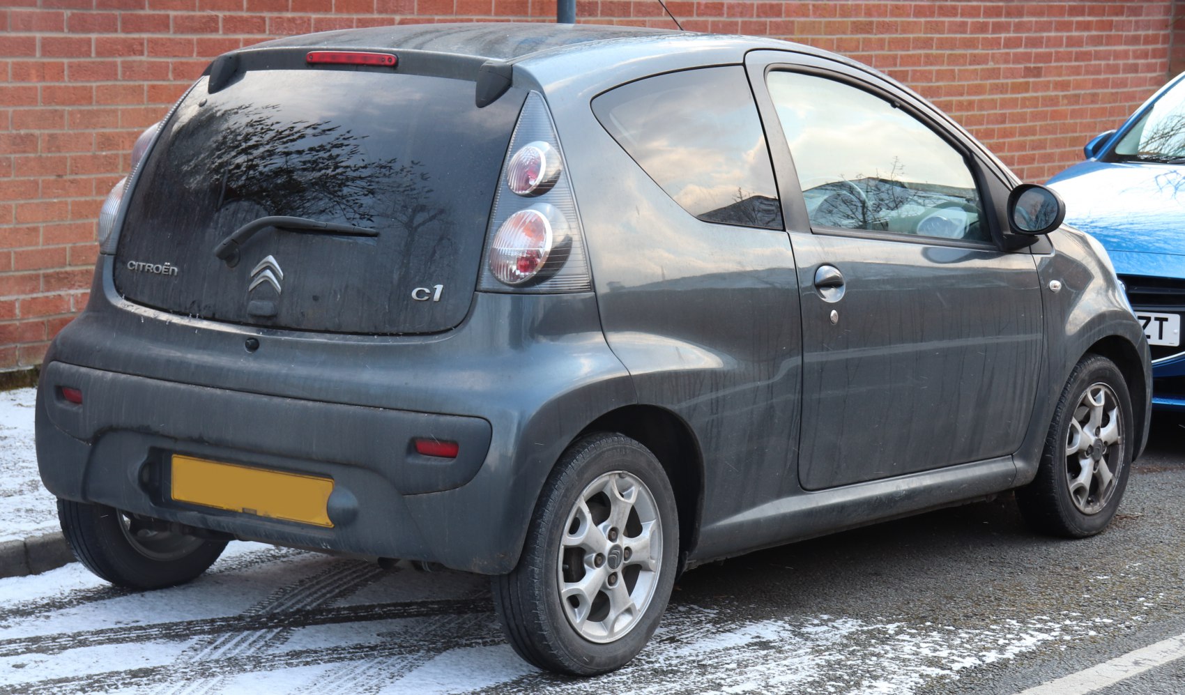 Compact 3-door hatchback rear with vertical dual round tail lights