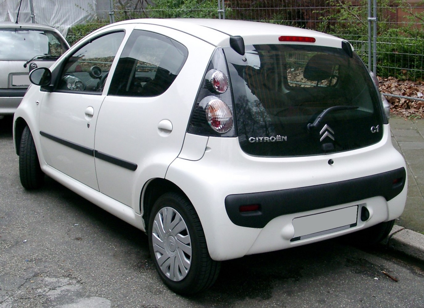 Compact hatchback rear view with vertical tail lights and rear wiper