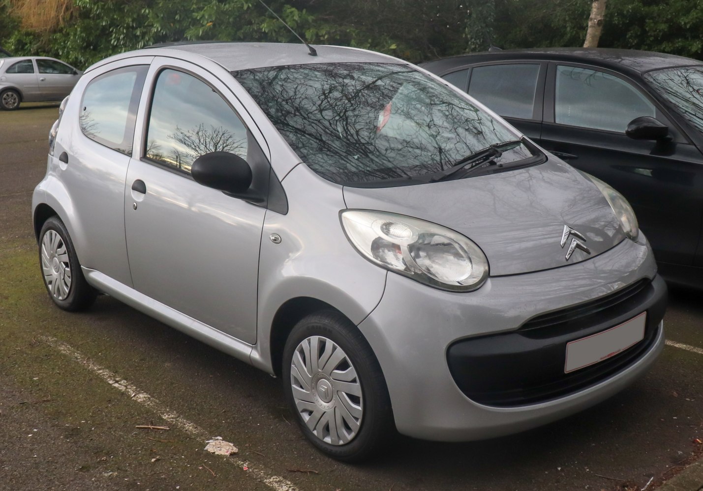 Compact silver 5-door hatchback with rounded headlights and black trim