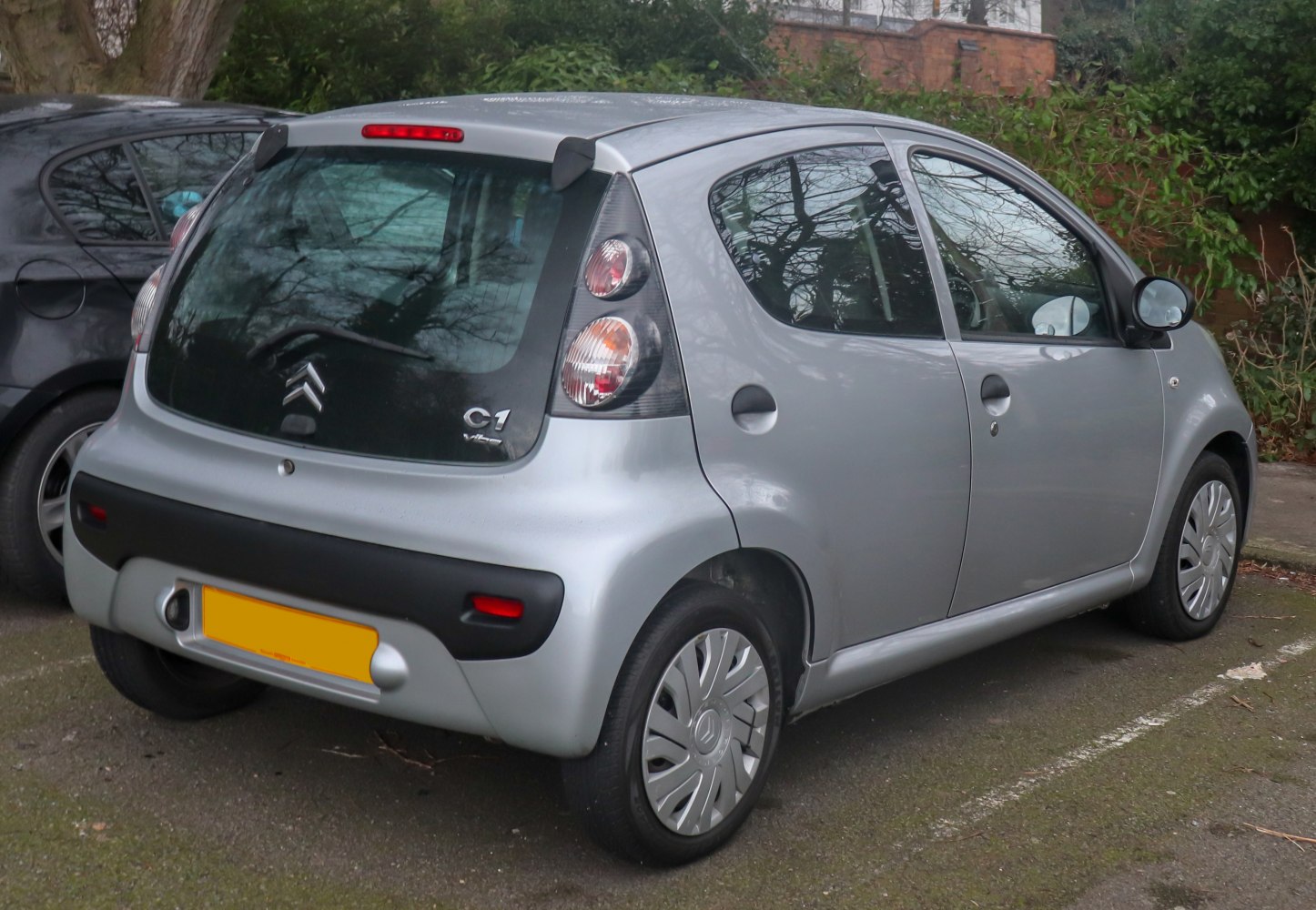 Compact 5-door hatchback with vertical tail lights and black bumper.