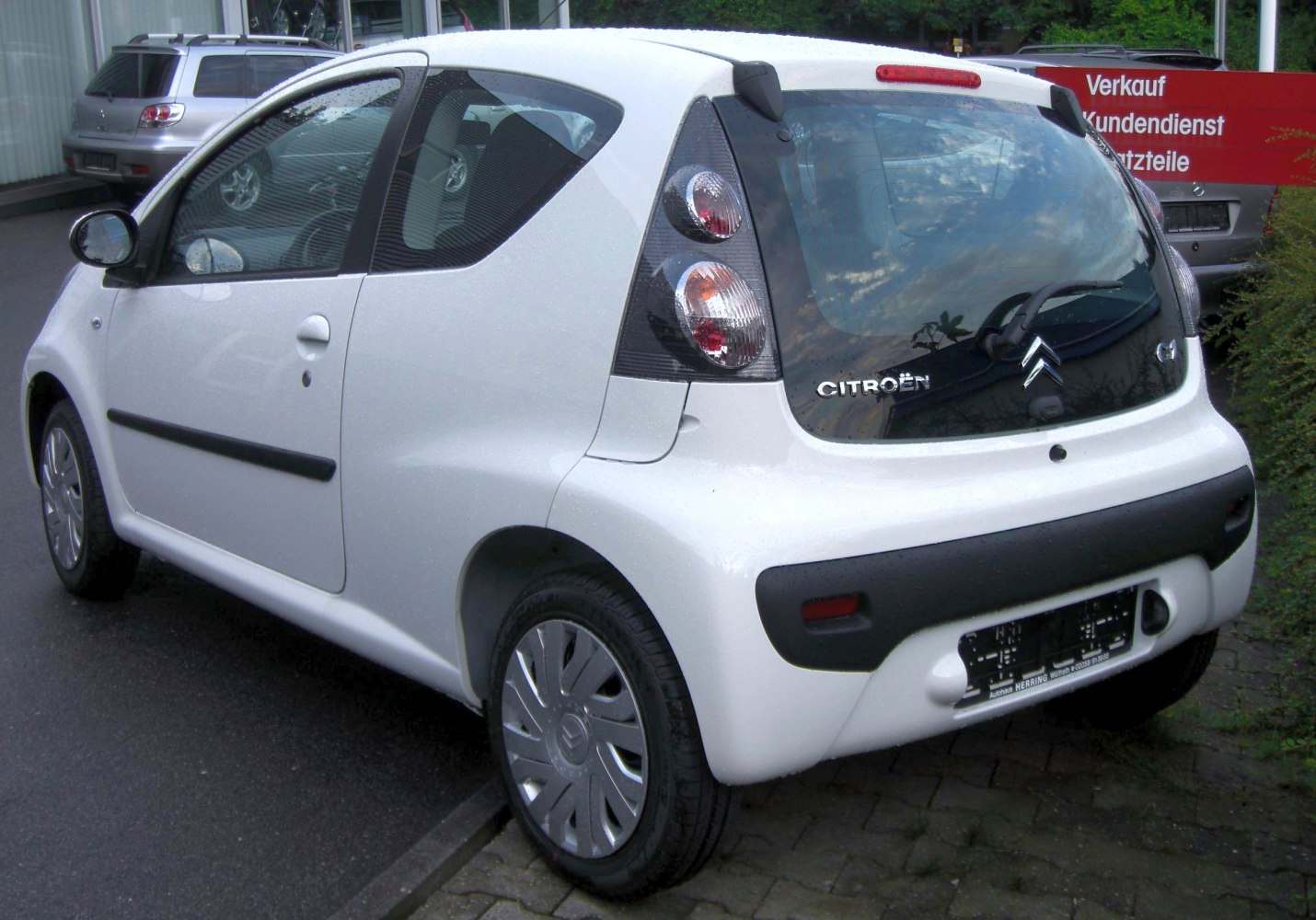 Rear side view of a compact 3-door hatchback with vertical tail lights