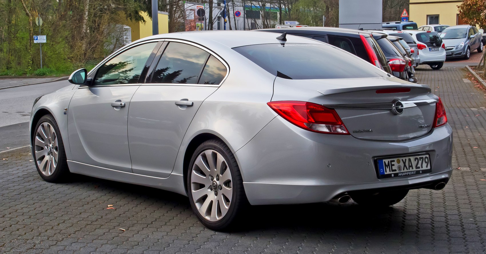 Rear three-quarter view of silver mid-size sedan with sleek lines and distinctive taillights