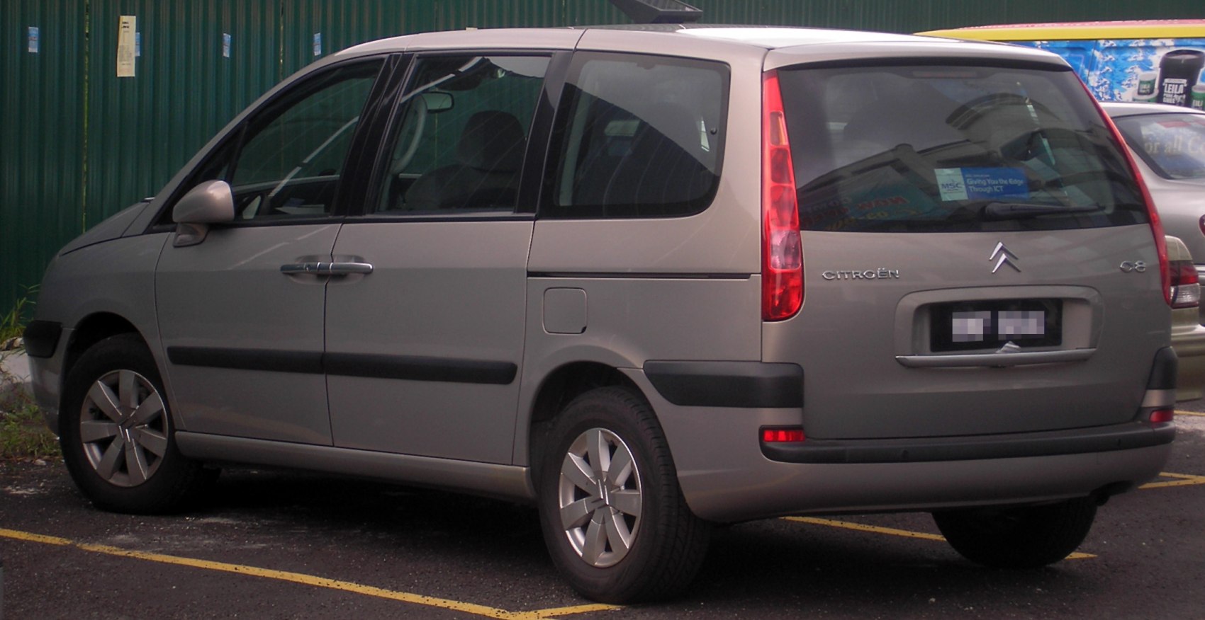 MPV rear side with vertical tail lights and alloy wheels