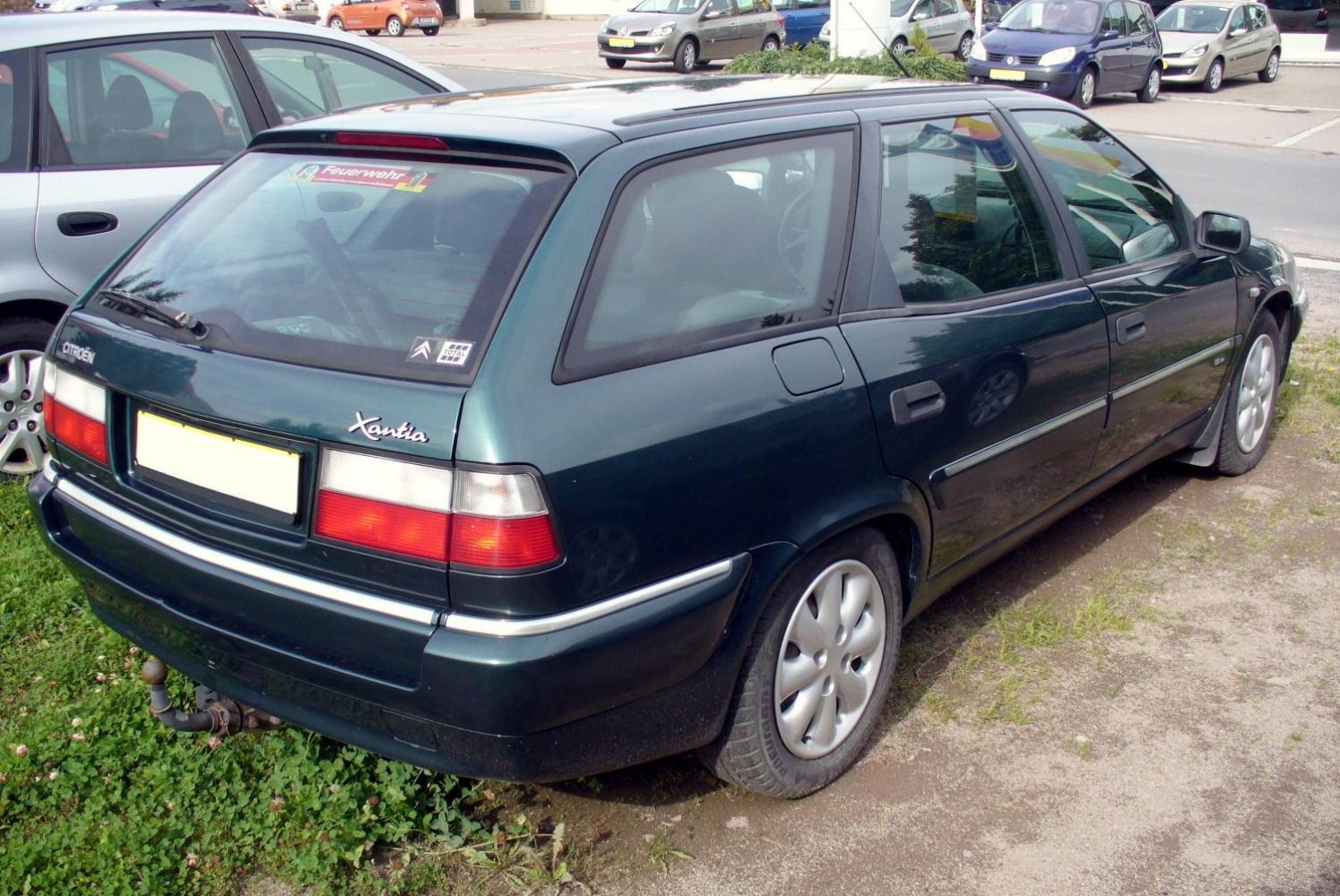 Estate car rear view with taillights, roof spoiler, and rounded wheels.