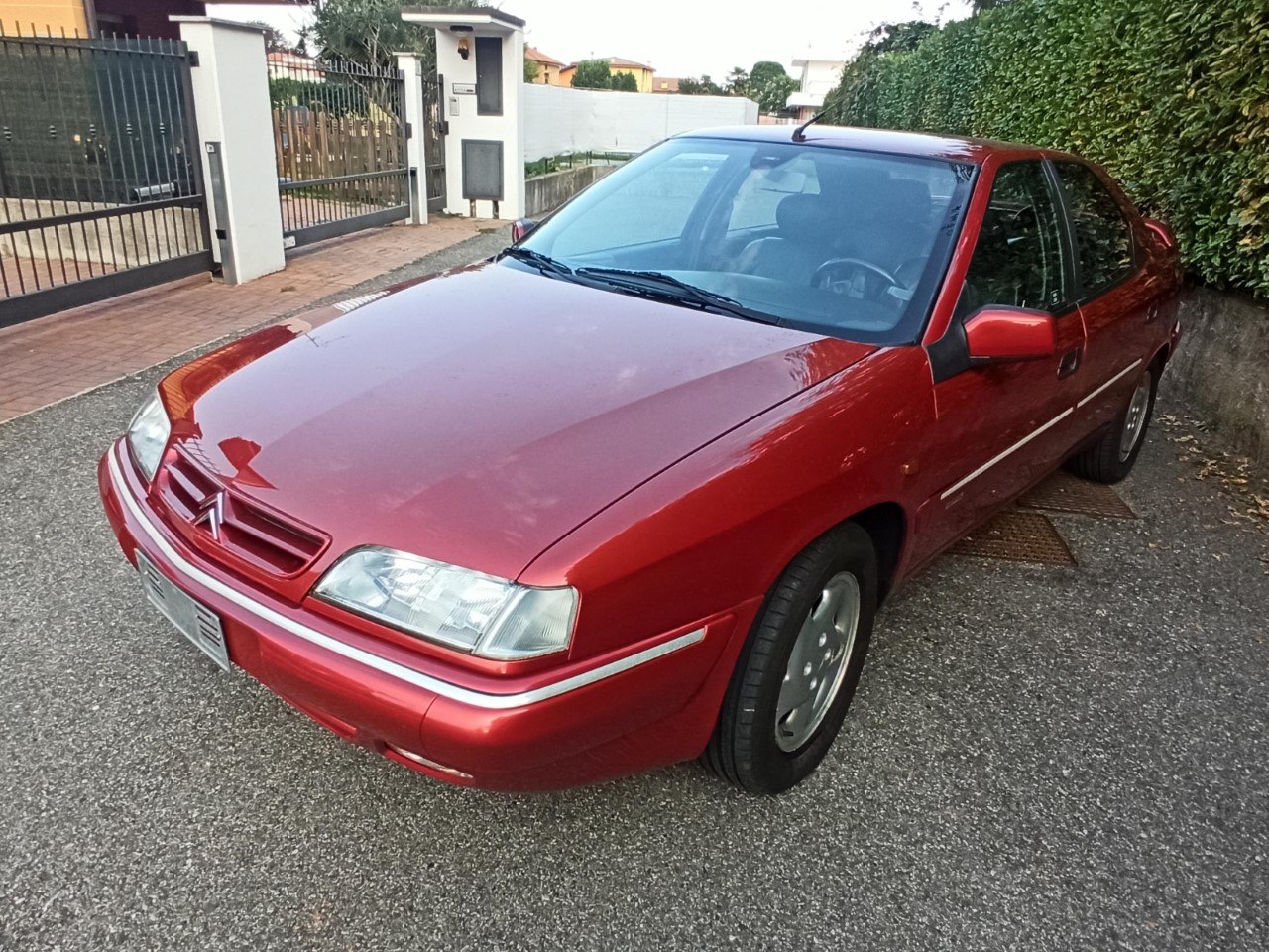 Red sedan with distinctive front grille and aerodynamic shape