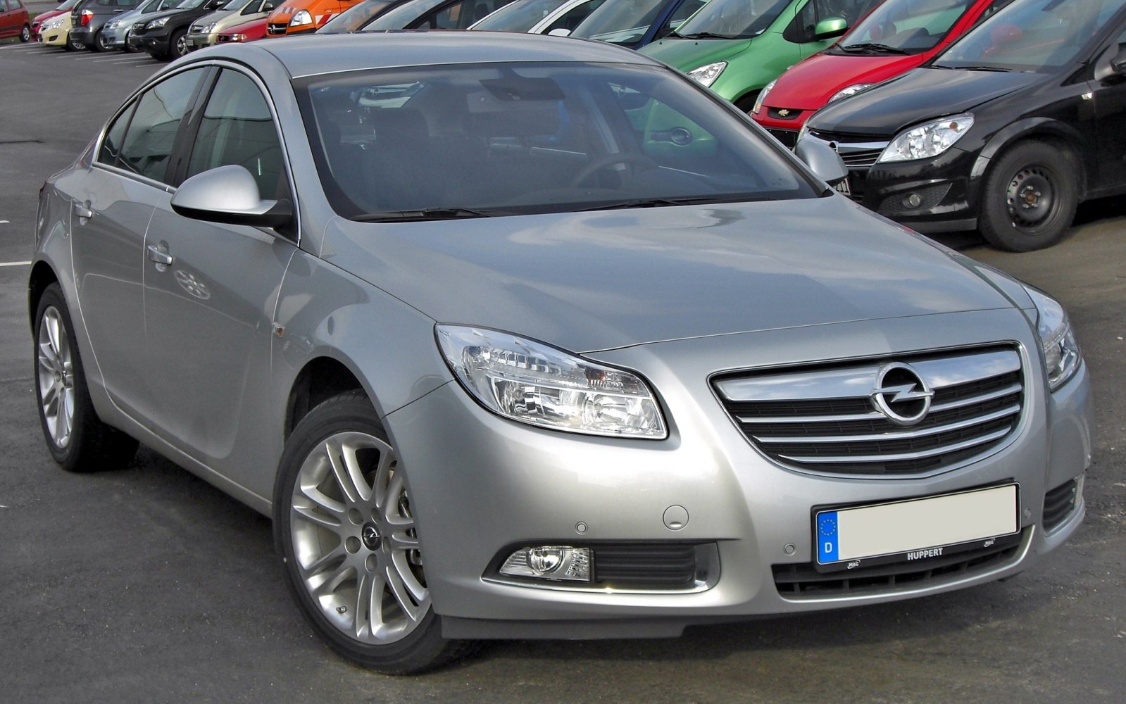 Front-side view of a sedan with alloy wheels and clear headlights