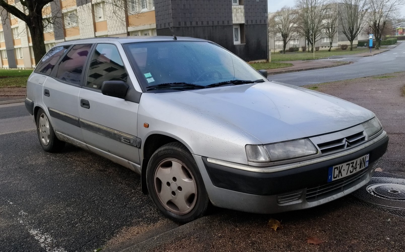 Front side view of a silver station wagon with distinctive angular design.
