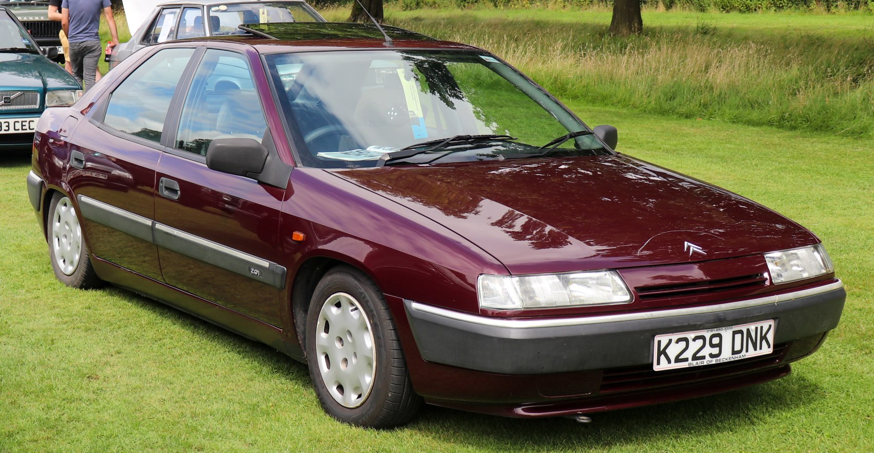 Aerodynamic front-side view with rectangular headlights and classic sedan design