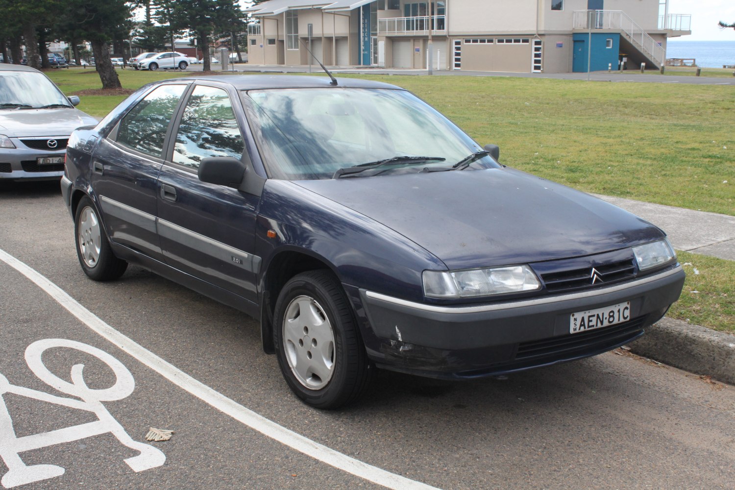 Front side view of car with headlights and alloy wheels