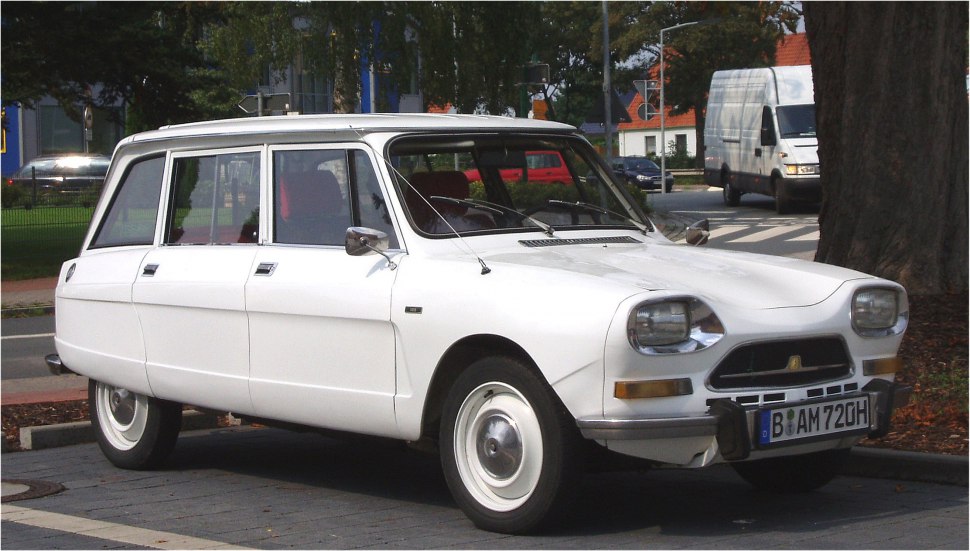 White classic vintage station wagon with distinctive square headlights and retro styling.