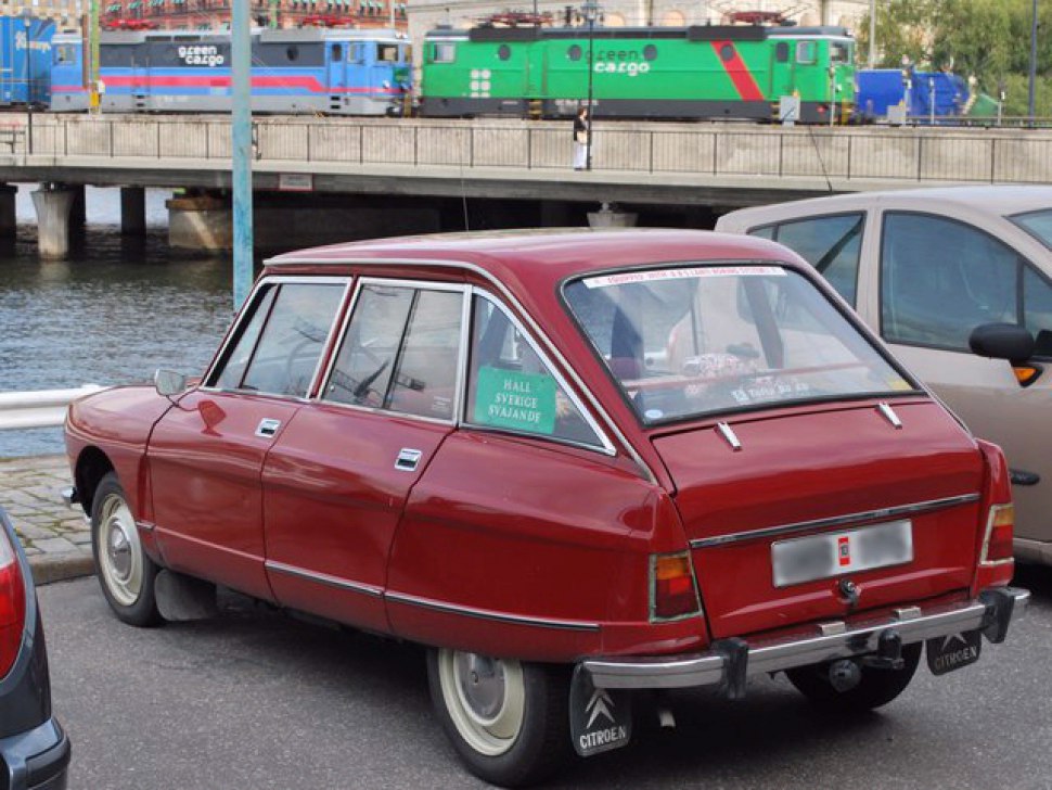 Red five-door hatchback rear with angular design and chrome trim.