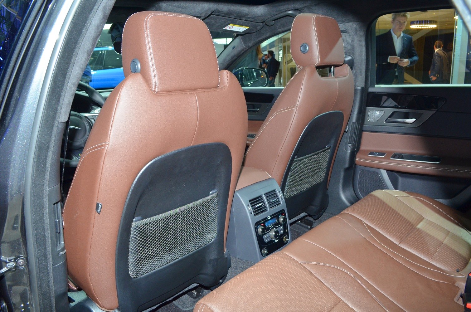 Rear interior with brown leather seats and climate control panel