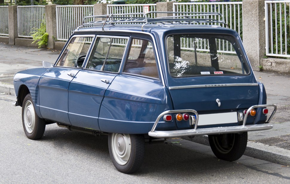 Rear view of classic blue vintage station wagon with roof rack and distinctive bumper