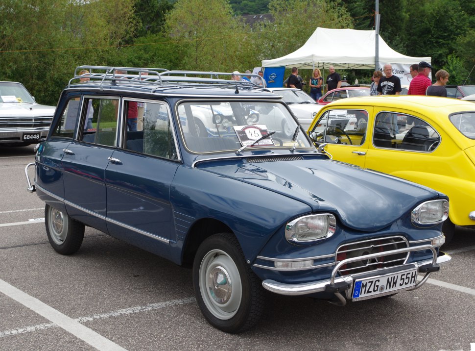 Vintage station wagon with slanted front, dual headlamps, and roof rack