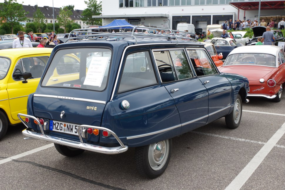 Rear view of vintage blue station wagon with roof rack and chrome bumper