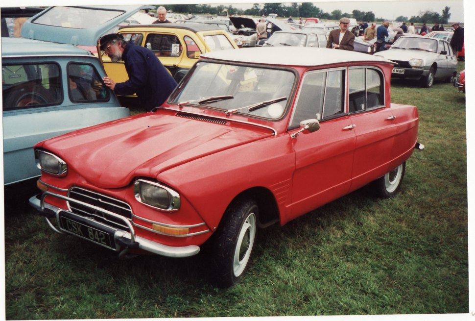 Red vintage car with rectangular headlights and retro grille