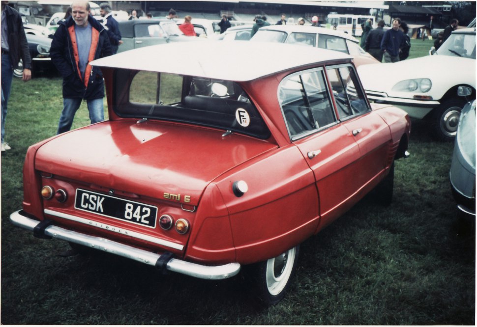 Rear view focusing on unique tail and window design of vintage sedan.