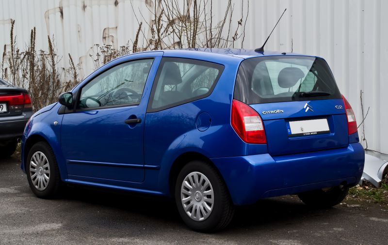 Blue 3-door hatchback rear side view with distinct taillights