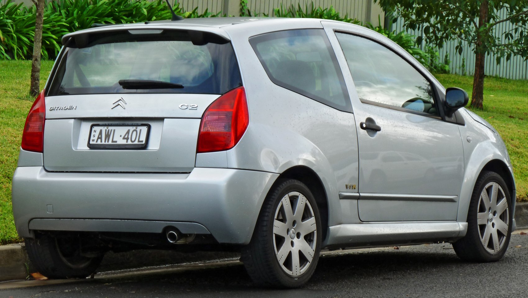 Rear and side view of a silver hatchback with distinctive tail lights and alloy wheels