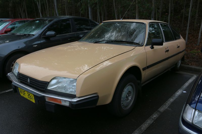 Beige vintage sedan with aerodynamic front and unique headlights